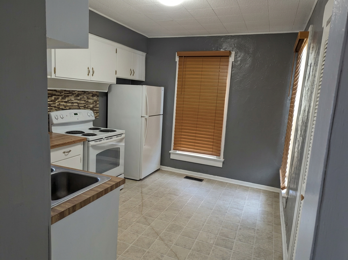 Kitchen with refrigerator and electric range