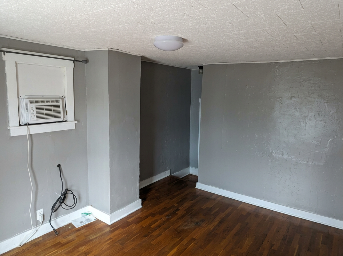 Upstairs bedroom with window air conditioning unit